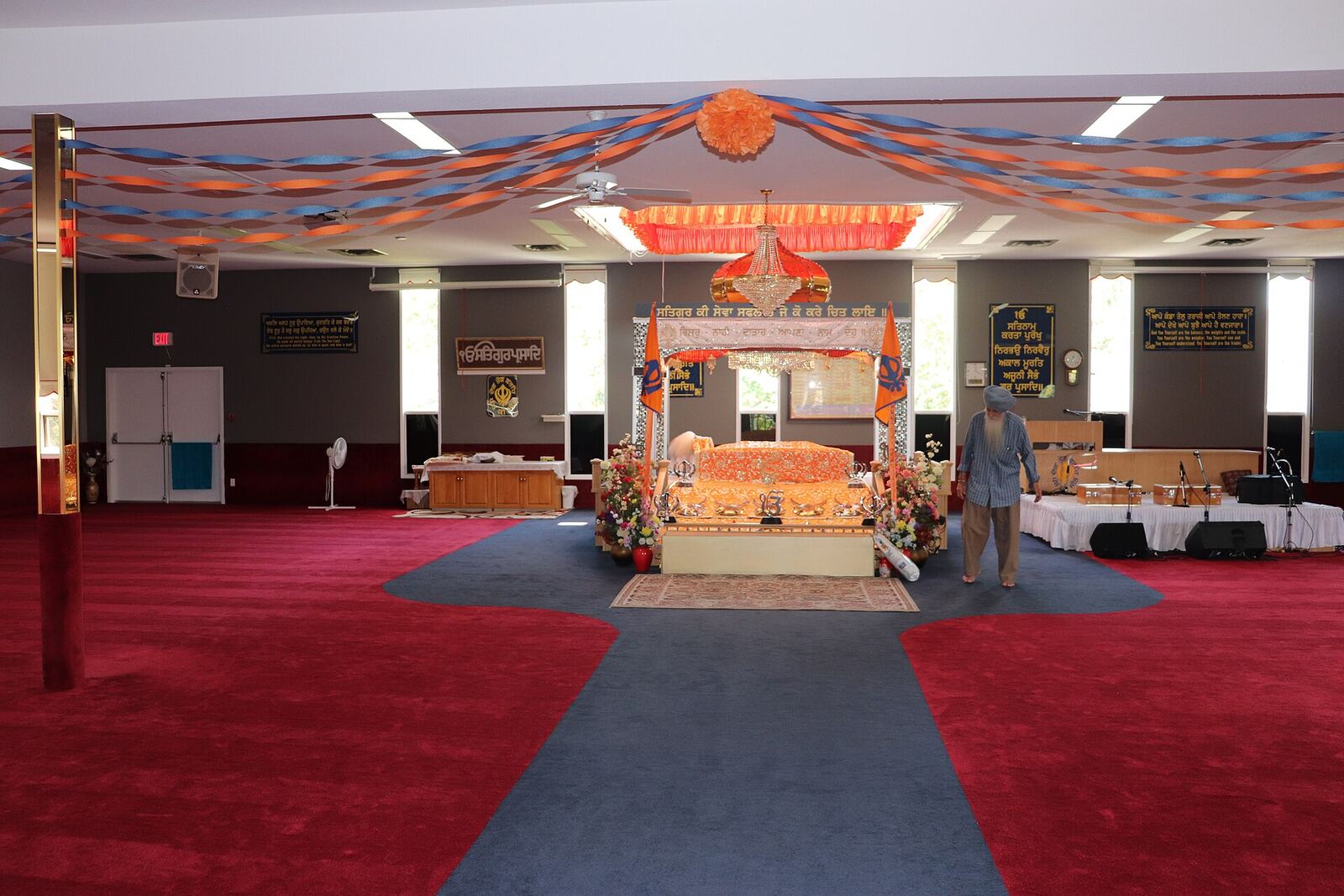 Gurdwara Main Hall | Sikh Saints A Gurdwara's main hall shows a central platform with covered scripture, representing Sikh faith and devotion.