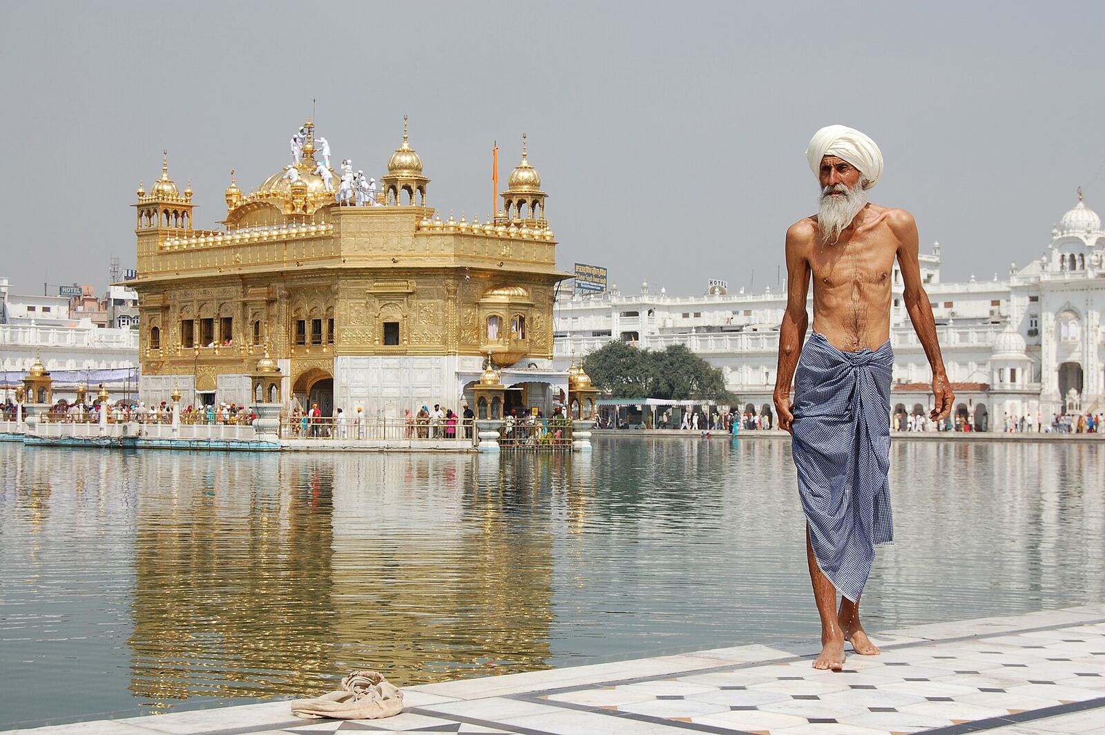 Sikh pilgrim at the Harmandir Sahib (Golden Temple) in Amritsar , India . The man has just had a ritual bath .